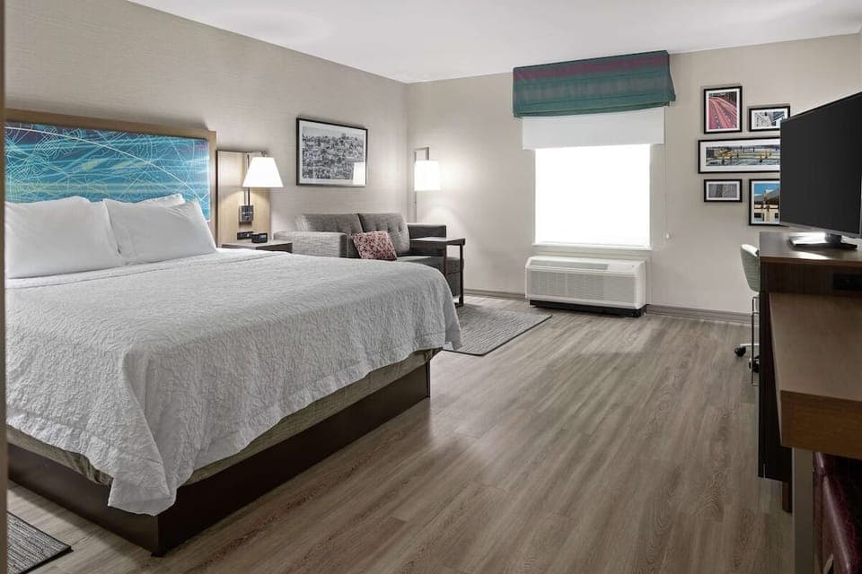Stretch out on a king bed in a sunlit room.