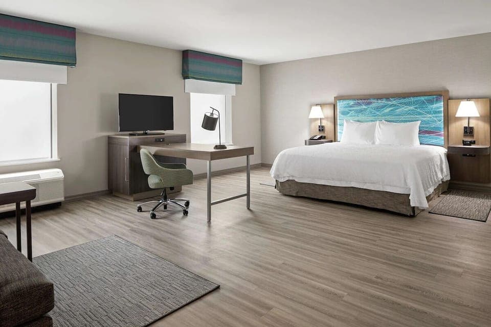 Unwind in a bright king room with dedicated workspace.