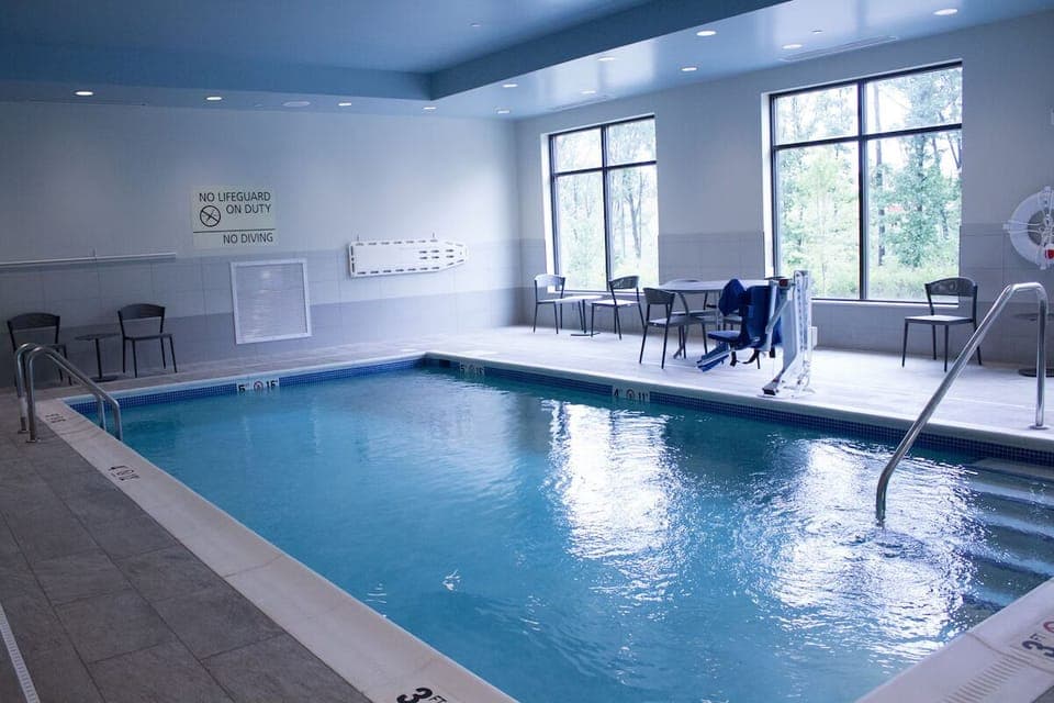 Swim leisurely in the calm pool with ample seating.