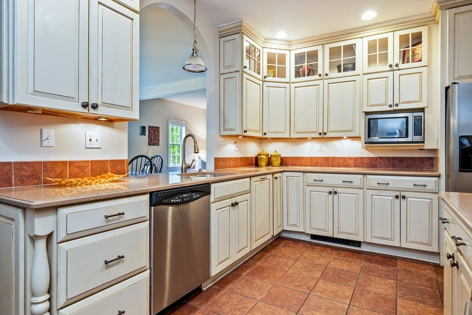 Elegant chef’s kitchen featuring custom cabinetry, granite counters, and stainless-steel appliances—perfect for cooking and gathering.