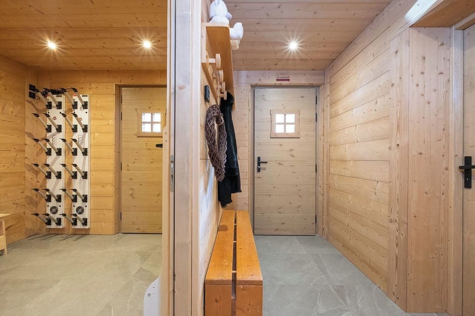 Heated ski room with electric boot dryer and convenient storage space.