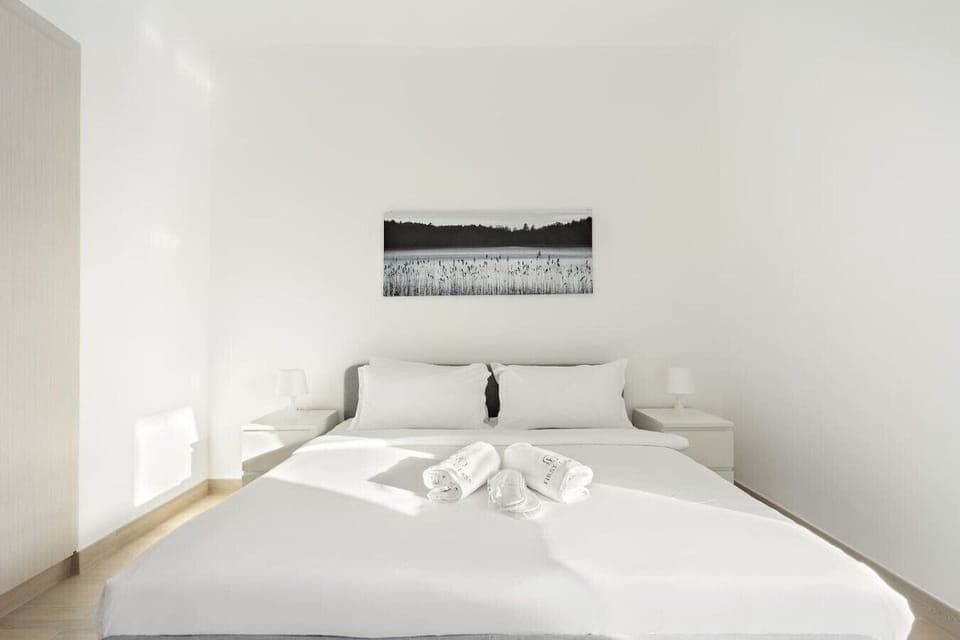 Bedroom Oasis: Sleek design with soft linens, serene artwork, and natural light to refresh your stay!