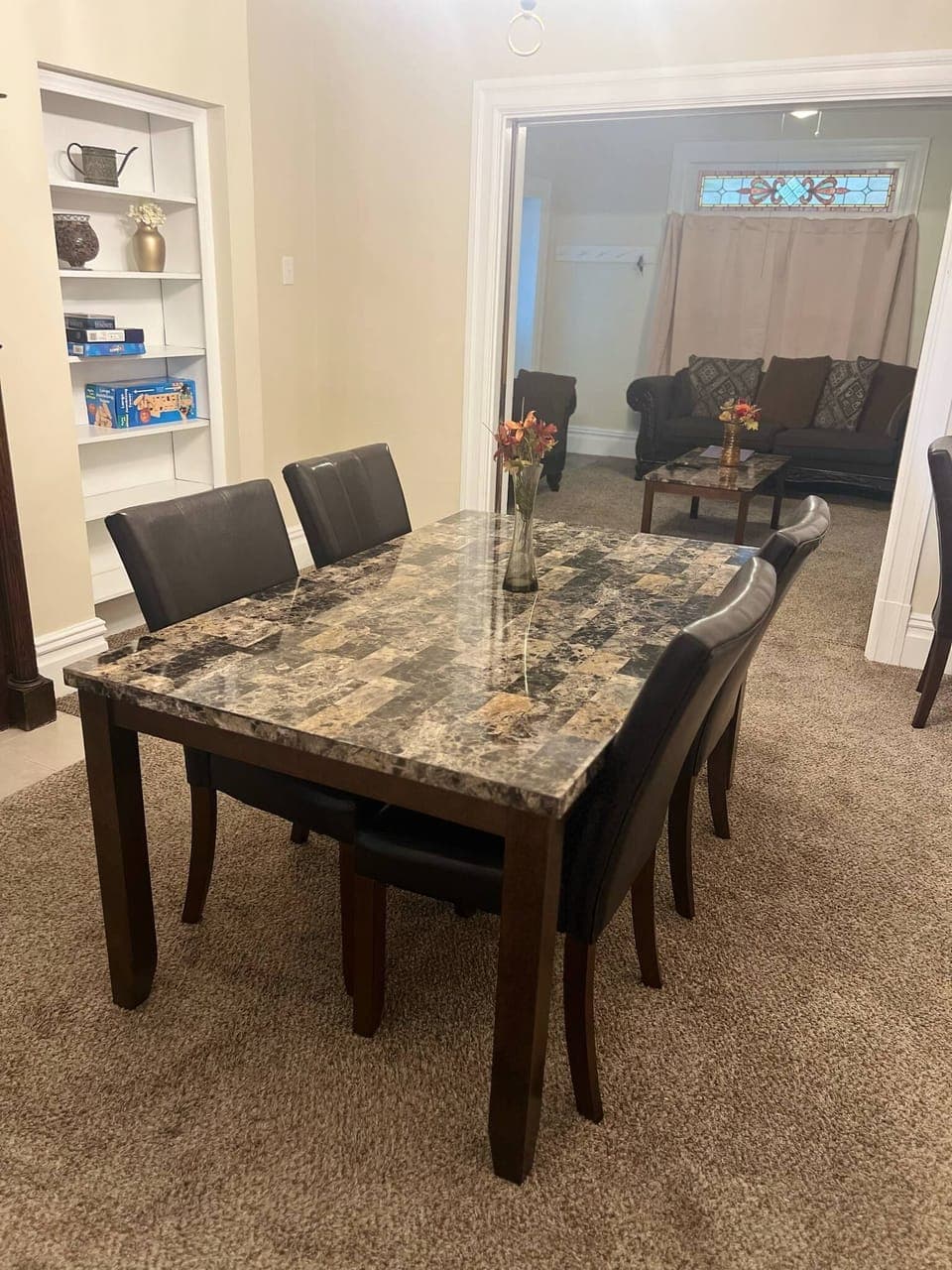 Spacious dining room with two windows and AC unit.