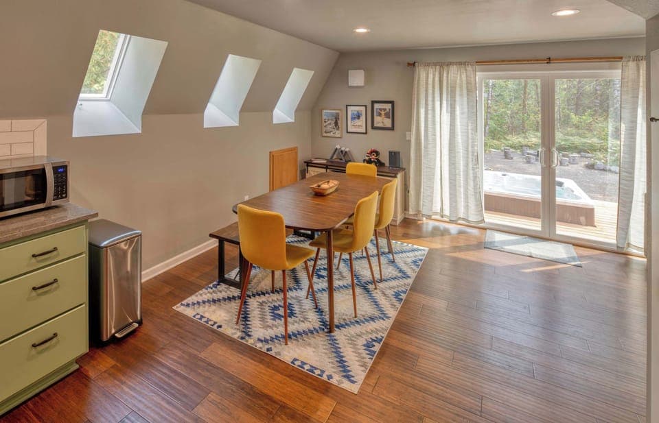 Dine with a view and easy hot tub access! This bright space is perfect for meals and relaxation. 