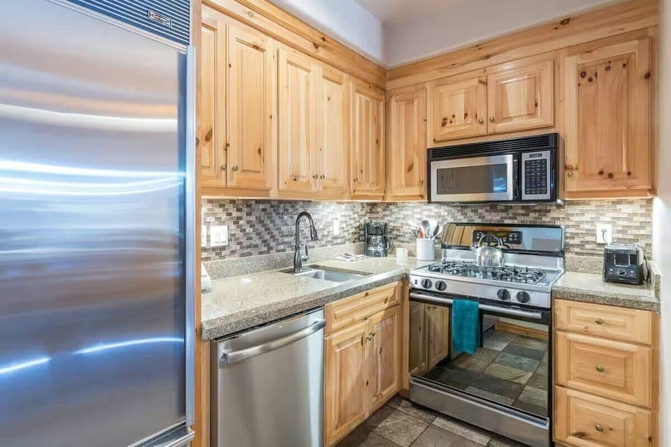 Kitchen: Main floor, drip coffee maker, toaster, Sub-Zero fridge, GE oven, cooking utensils, tableware

