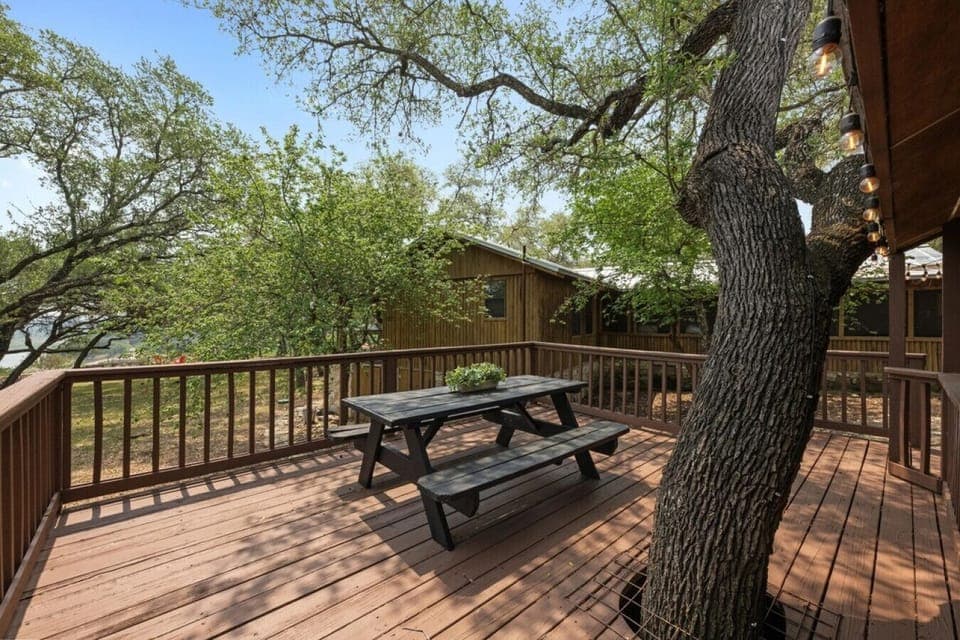 Take in partial lake views while relaxing or dining outdoors on this spacious shaded deck—complete with a picnic table and cozy string lights.