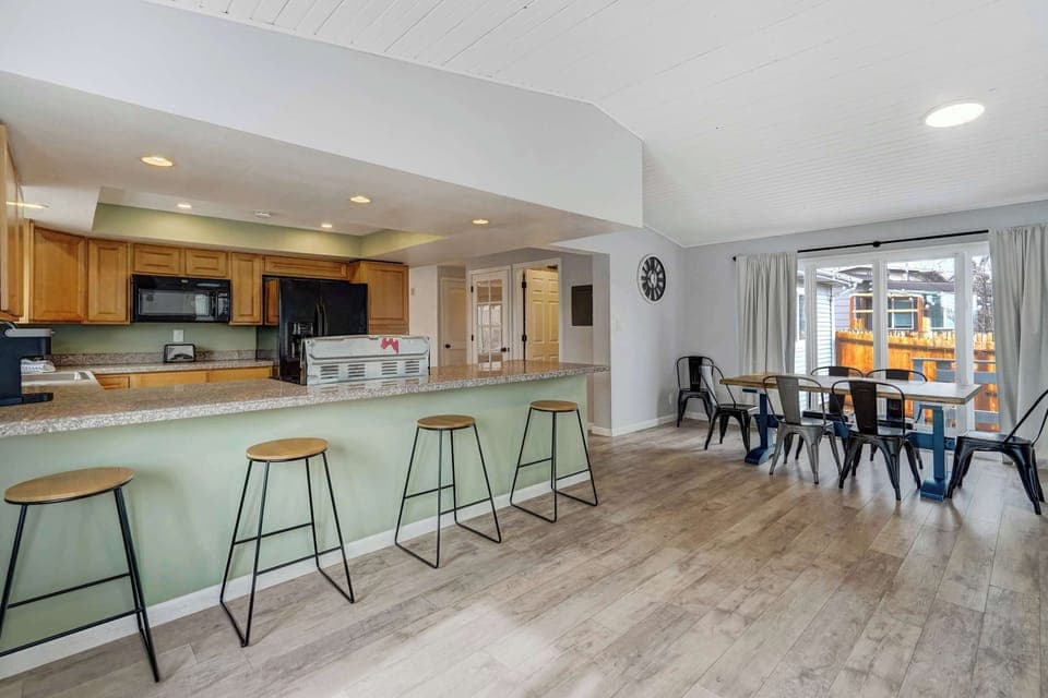 Bright and airy space with vaulted ceilings, large windows, and easy access to the outdoor deck—perfect for seamless indoor-outdoor living.