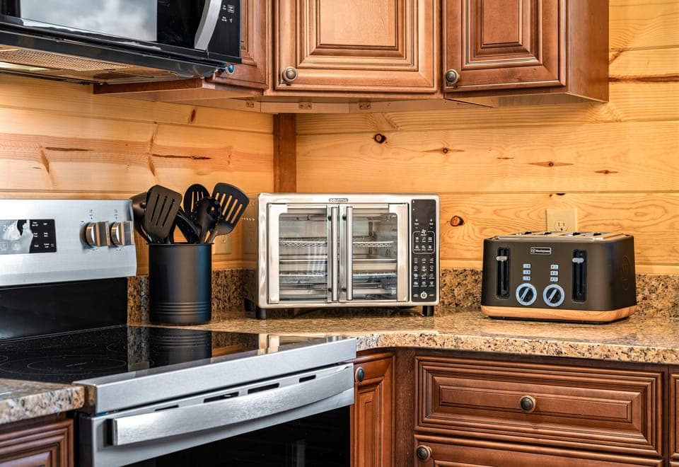 Kitchen with stainless steel appliances and all the essentials for home cooked meals. (House 1)