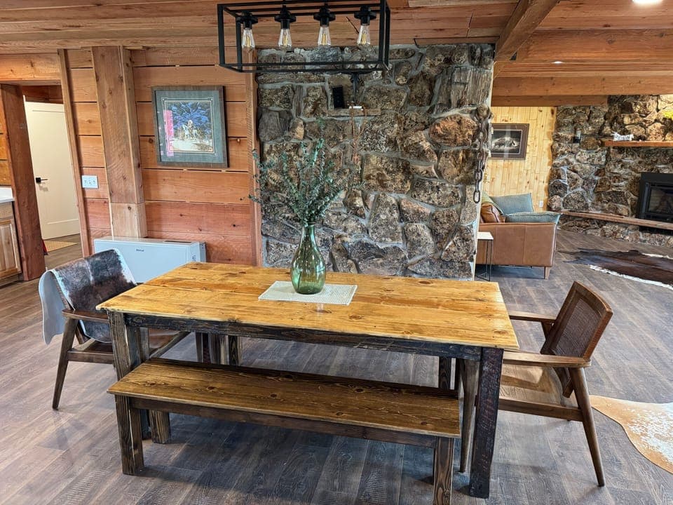 Dining table adjacent to open-area kitchen and island