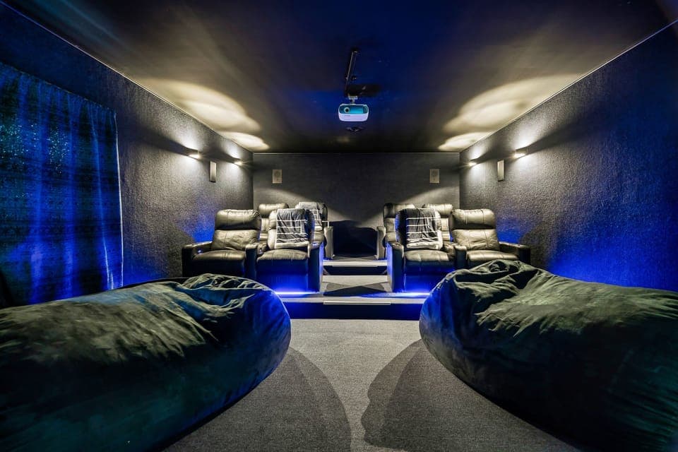 Main house movie theater with bean bags & carpet walls. Fully reclinable chairs.