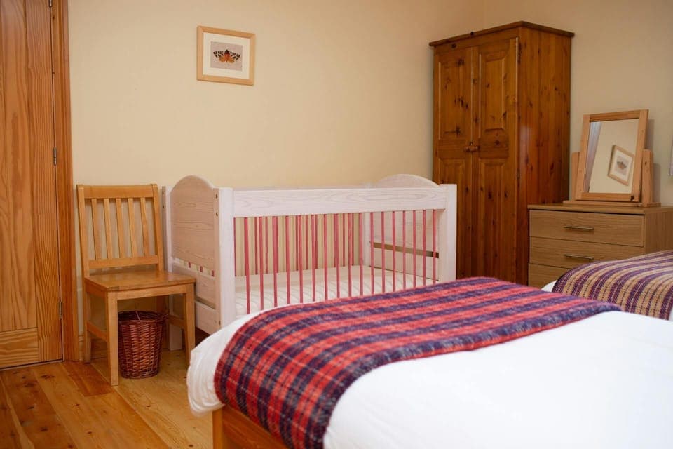 Twin bedroom with full size cot, dressing table and wardrobe