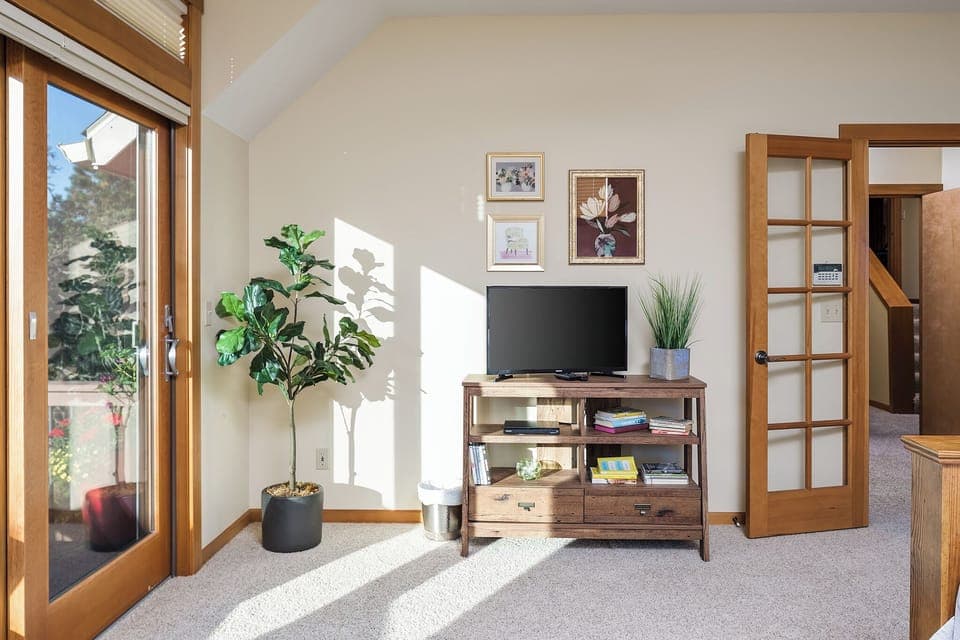 Primary Suite with smart tv, reading nook, pull out couch, and private balcony