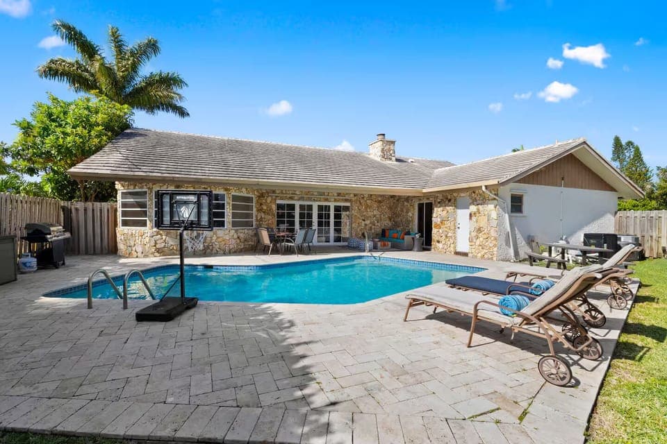 Spacious pool deck with basketball hoop and full sun for all-day fun.
