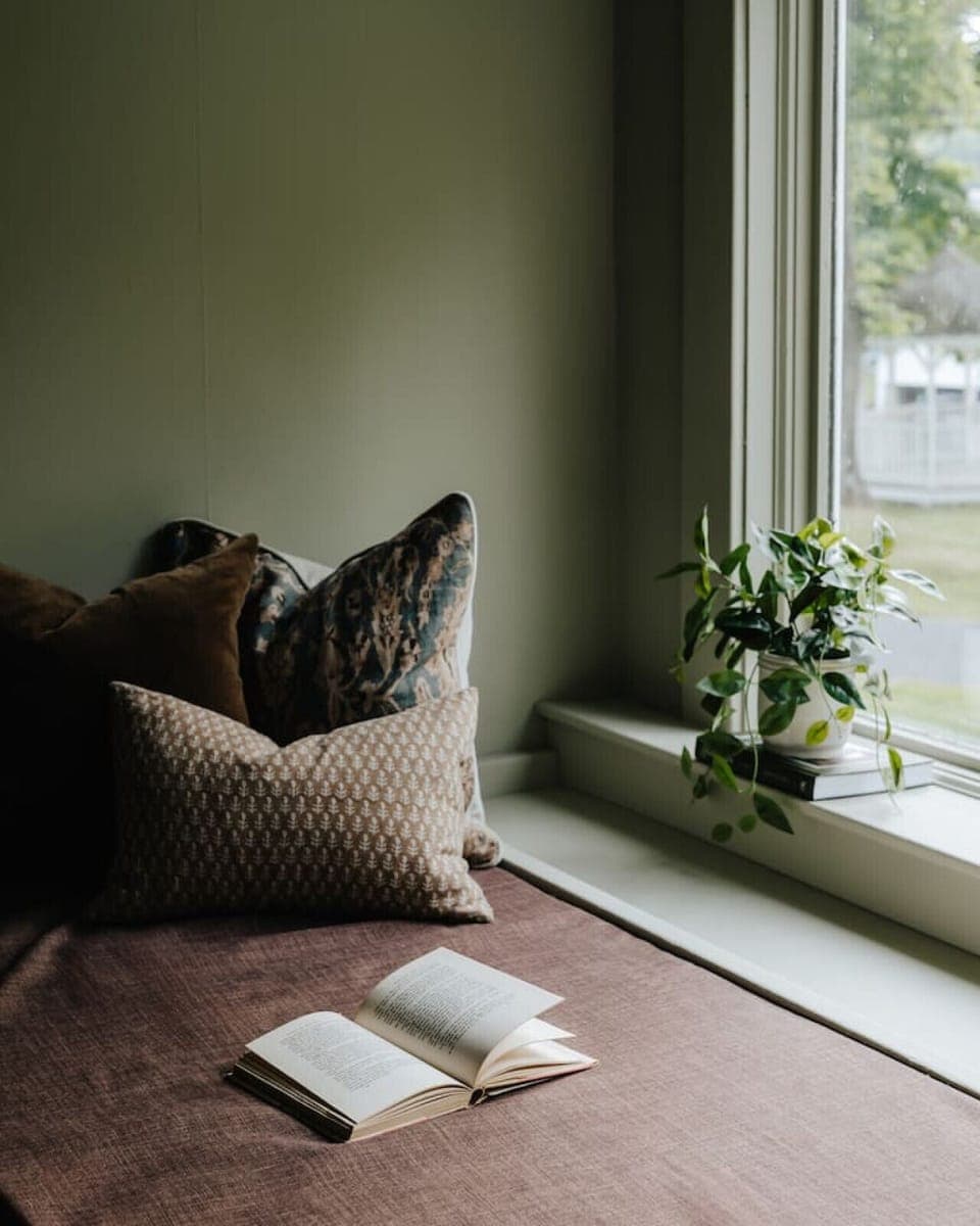Unwind with a peaceful moment by the window, offering a quiet retreat and cozy seating.