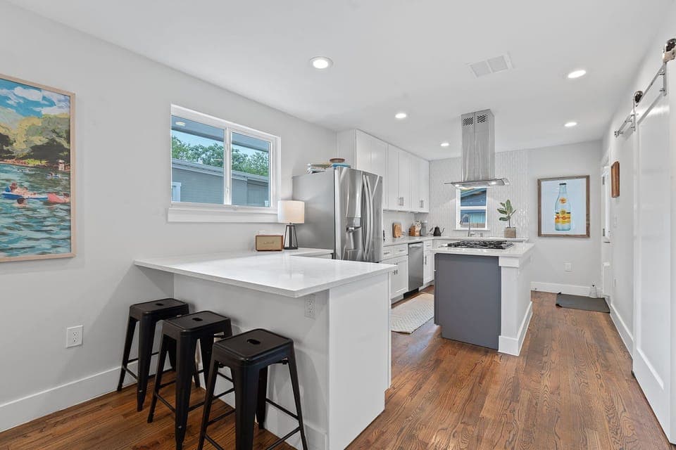 The fully equipped kitchen boasts sleek quartz countertops, brand-new appliances, and a seamless flow into the living and outdoor spaces, making it easy to cook, dine, and entertain.
