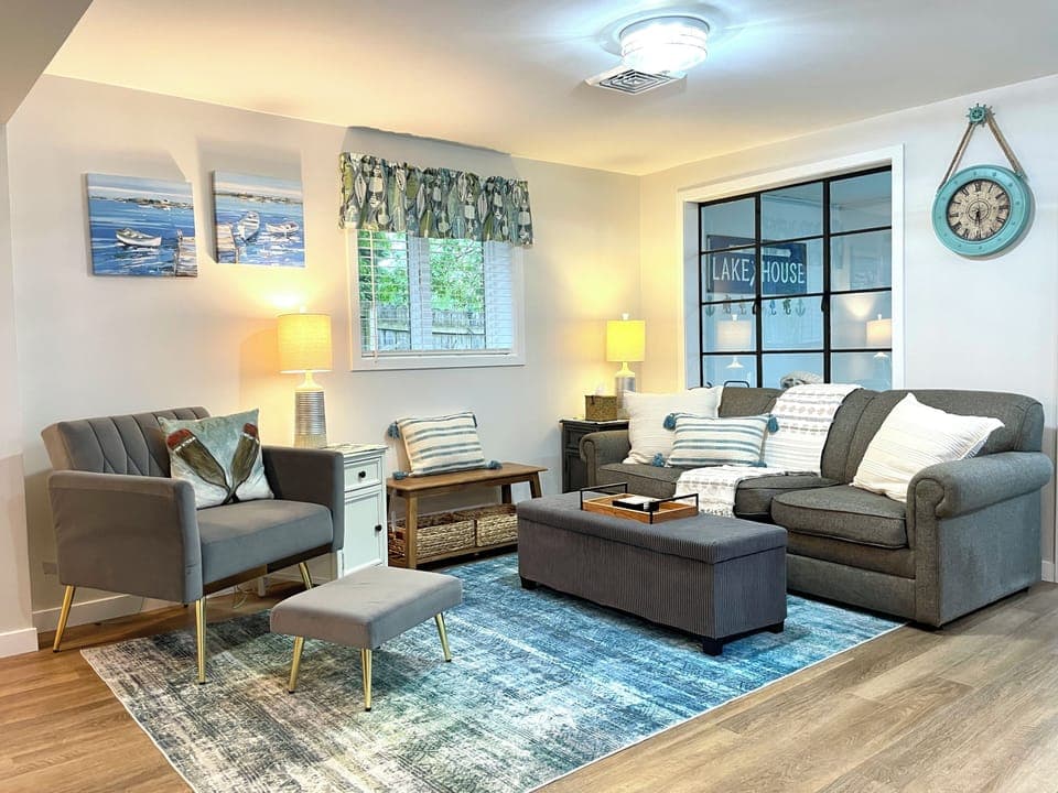 Stone Lake Cottage Retreat: A comfy place to unwind — pull-out sofa for extra guests, plus a cozy chair for solo coffee sipping.