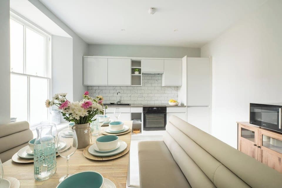 A fully equipped kitchen featuring all the essentials and modern appliances, perfect for family meals. This bright space overlooks the courtyard, providing an ideal setting for cooking together.