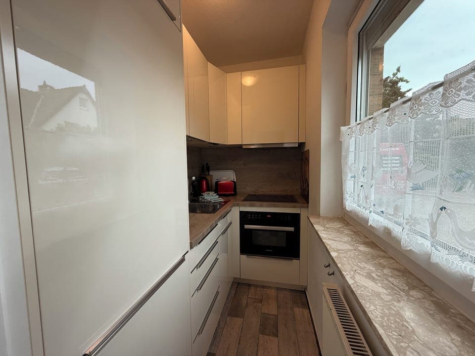 modern kitchenette, equipped with oven, stove, coffee machine, kettle and fridge-freezer