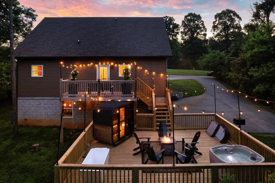 Unwind on the deck with a fire pit, hot tub, and string lights under the stars!