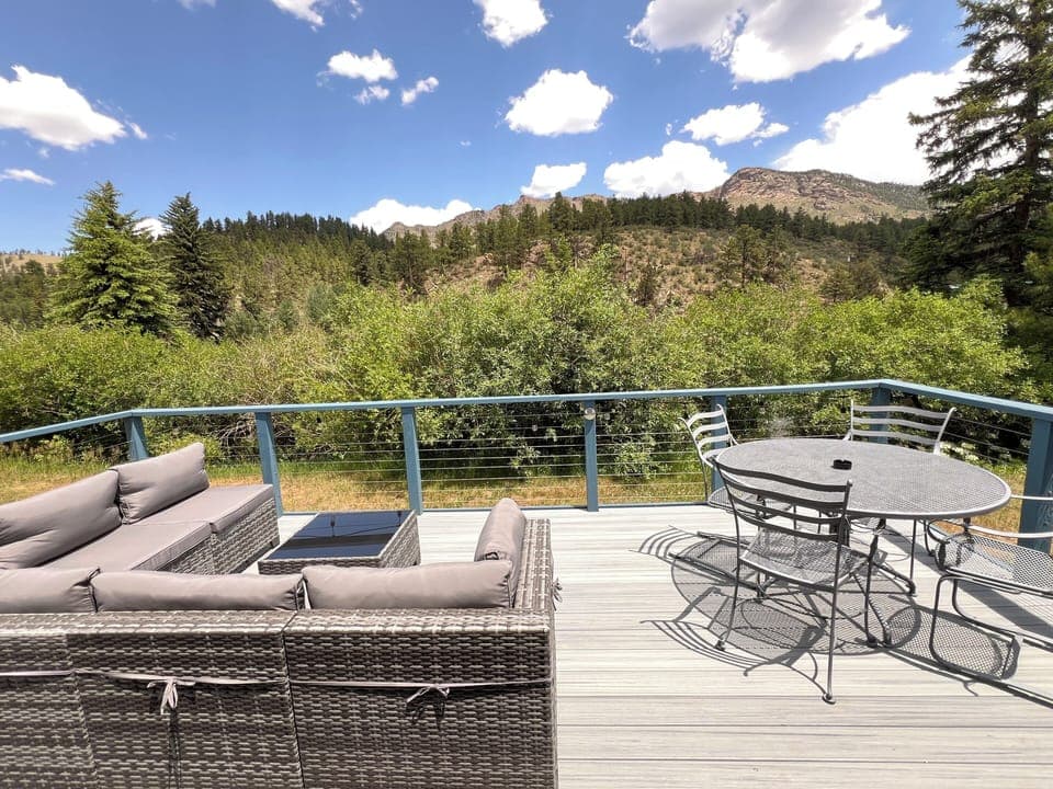 Soak in the serene forest views and mountain skyline from your private furnished deck