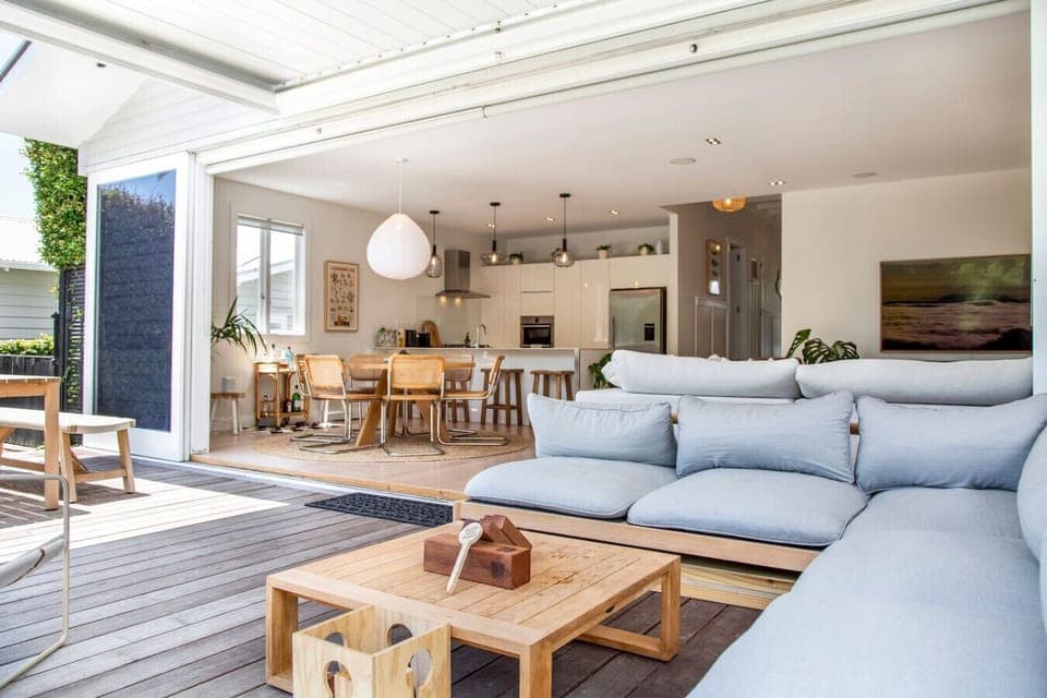 Outdoor living at its best. The bifold doors open up to reveal two more living spaces. There is an outdoor dining room and lounge that fits perfectly with the landscaped backyard. You get the benefit of a top-knotch designer and architect.