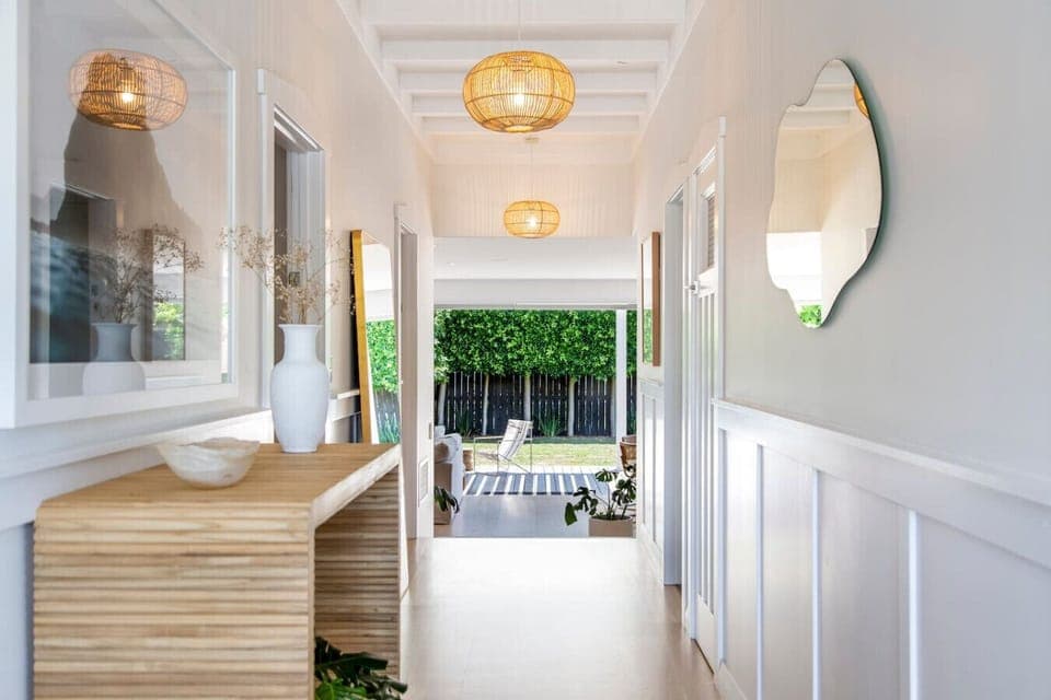 The great thing about this home is that it has the width and light that the earlier design predecessor the villa invariably lacked. The lighting helps to show off the painted paneling and reflects off the polished wooden floors.