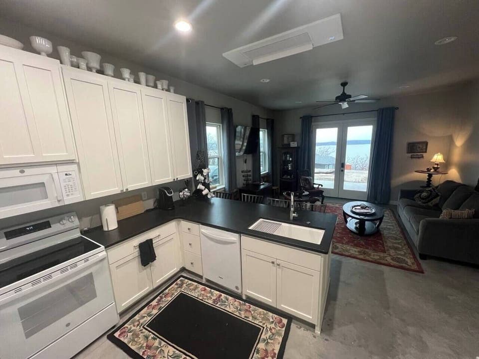 Fully modern kitchen with brand new appliances and equipped to support Full meals. If you need it and can't find it, just ask us, we can probably help out. We live across the street, and we're good neighbors! Note the eat at bar. 
