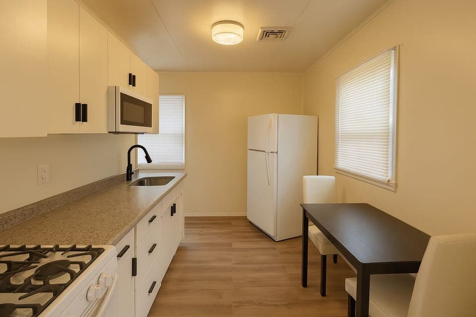 Kitchen with gas stove, full size refrigerator and microwave