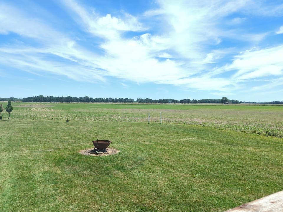 Fire pit in the backyard, shared with downstairs guests.  Fields behind the house.