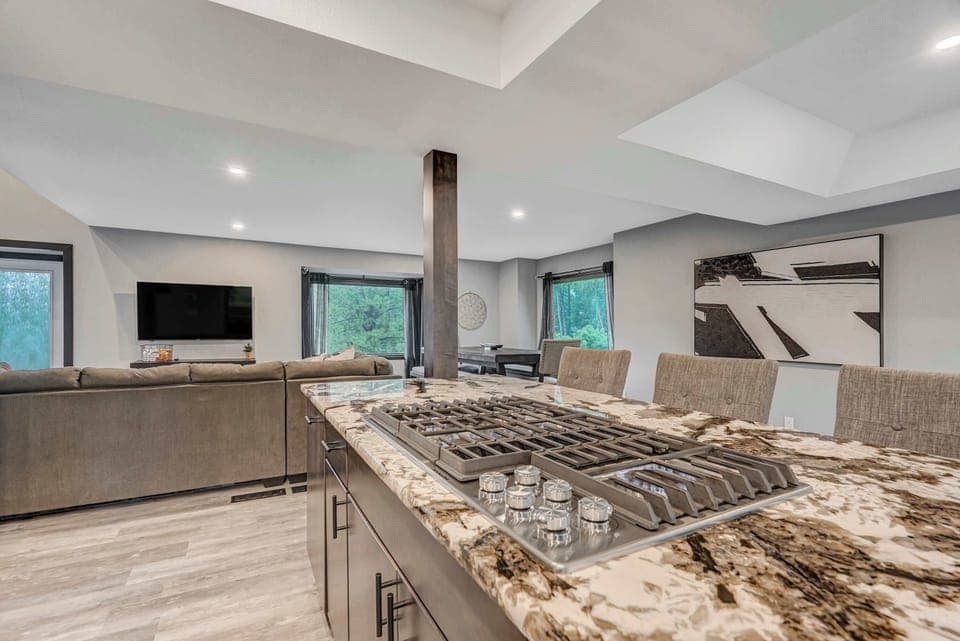 Cook while staying connected—this granite island with built-in gas range opens directly to the living and dining areas.