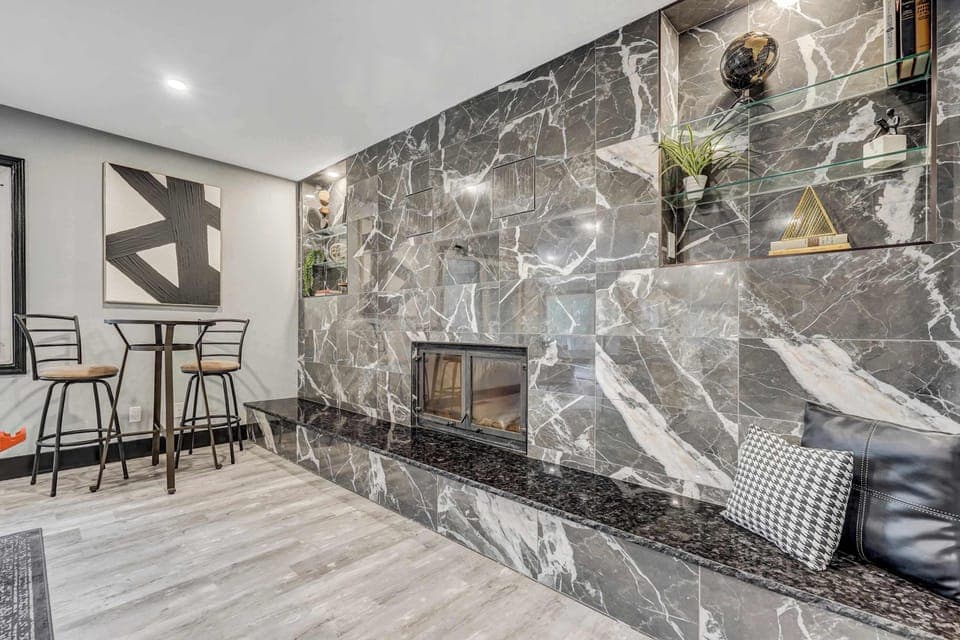Elegant stone fireplace with built-in seating—adds warmth, style, and a cozy place to unwind after a day of adventure.