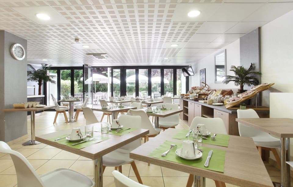 Spacious breakfast room with natural light and modern decor, where guests can enjoy an optional buffet each morning.