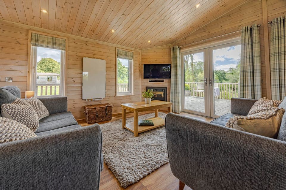 Living Room with sofa, TV and electric log burner