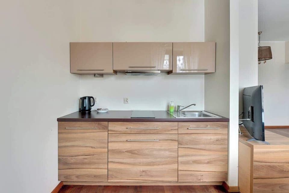 A functional kitchen featuring modern wooden cabinetry, a neutral color palette, and ample counter space, perfect for cooking and entertaining.