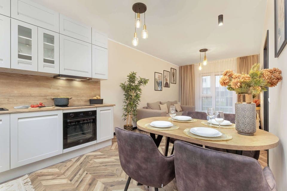 A dining table set for two, featuring plates, glasses, and an elegant centerpiece.