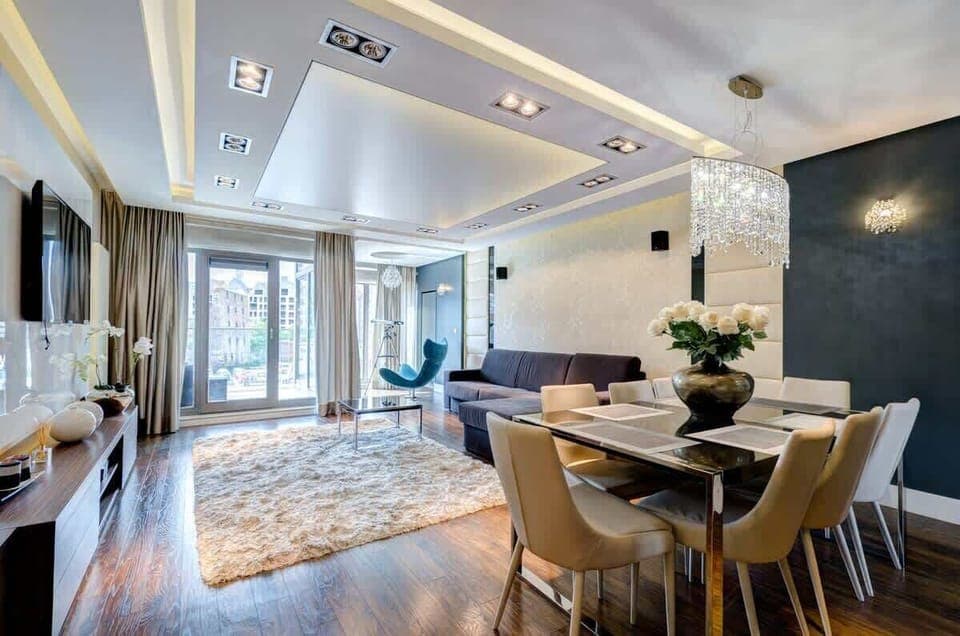 Contemporary dining area with elegant chairs and large windows bringing in natural light.