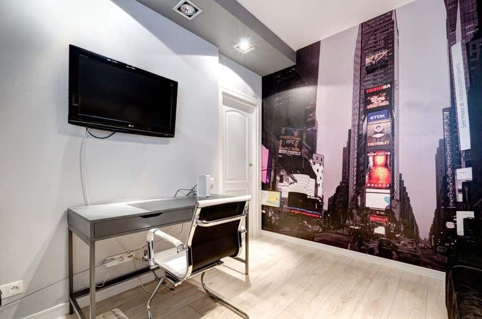 Compact work area with entertainment options, perfect for business travelers.