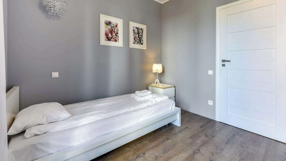 Comfortable single bed in bedroom with two single beds.