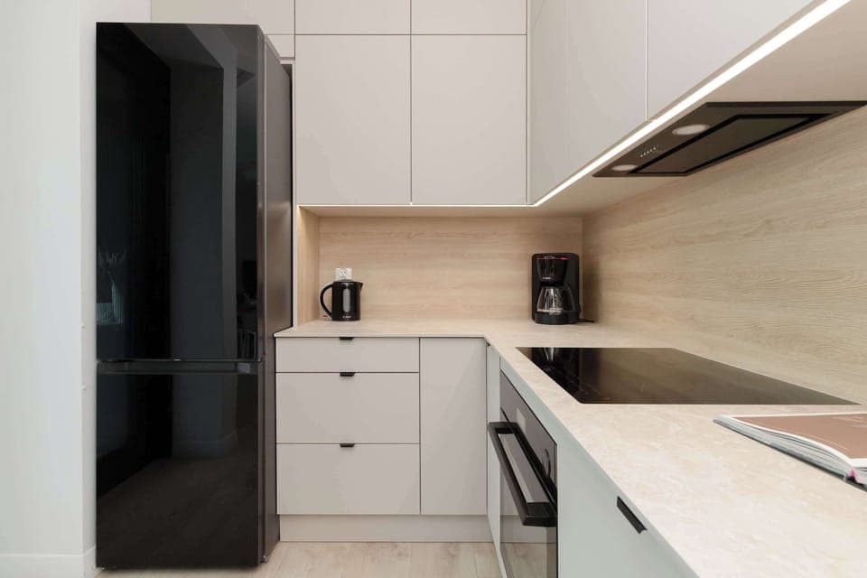 A fully equipped, modern kitchen with built-in appliances and ample storage.