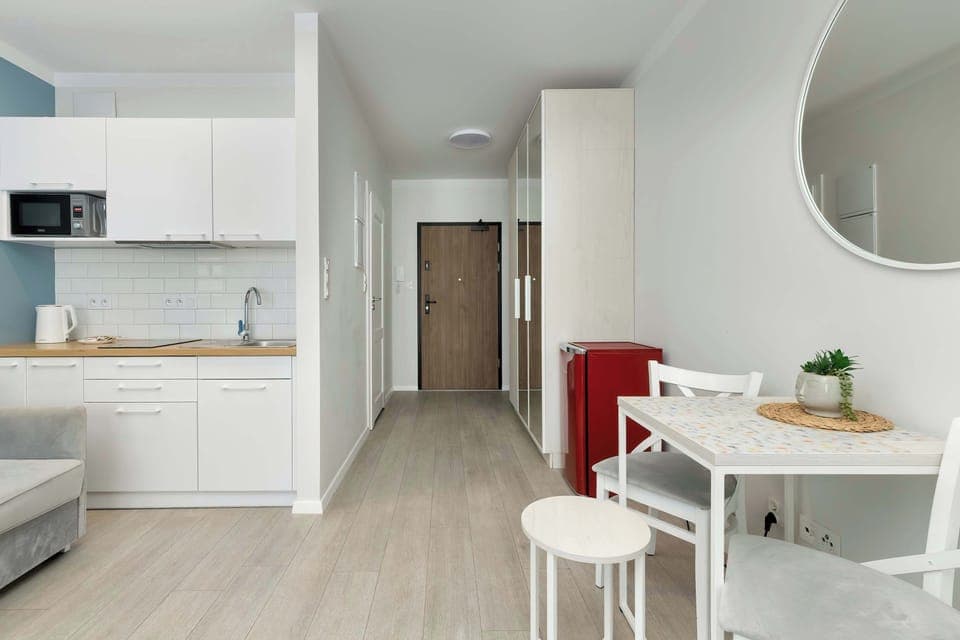 Open layout combining the kitchen, dining space, and entrance hallway.