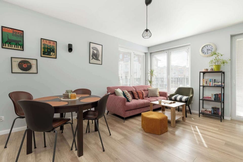 A spacious and bright living room invites shared meals and long conversations in natural light.