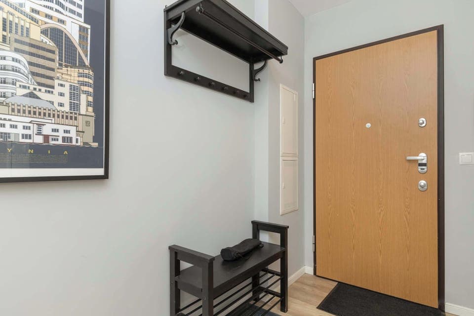 A spacious hallway with a convenient spot for shoes and jackets welcomes guests right at the entrance.