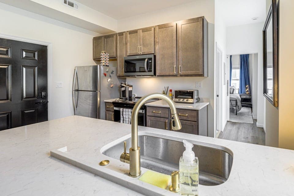 Modern kitchen design effects, gold tone fixtures, soft close cabinets & drawers