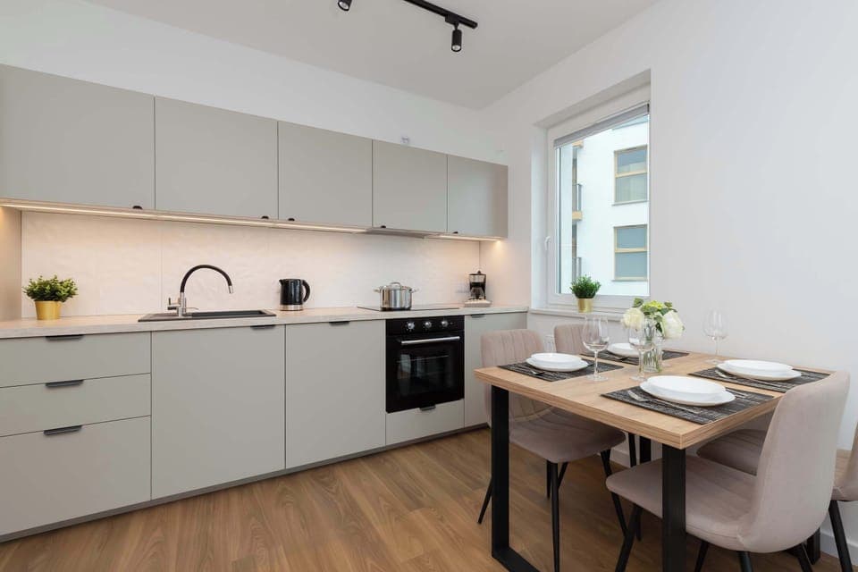 A modern kitchen with a spacious countertop and full equipment makes cooking at home effortless.

