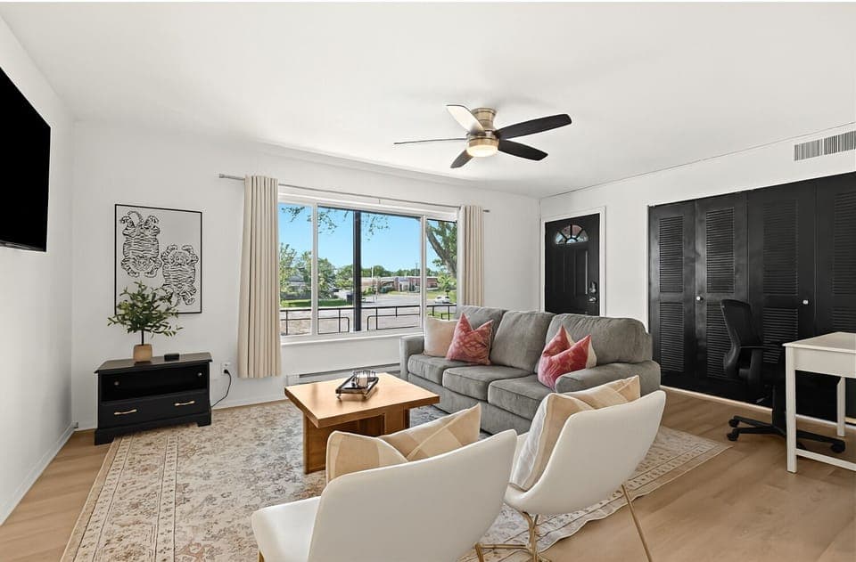 Wake up to sunshine in this beautifully lit bedroom with premium linens and modern decor.