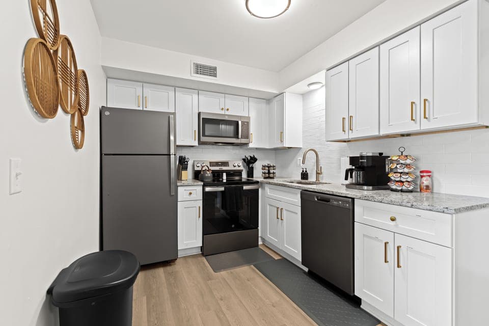 Contemporary kitchen and dining setup with bar-height seating and polished finishes.