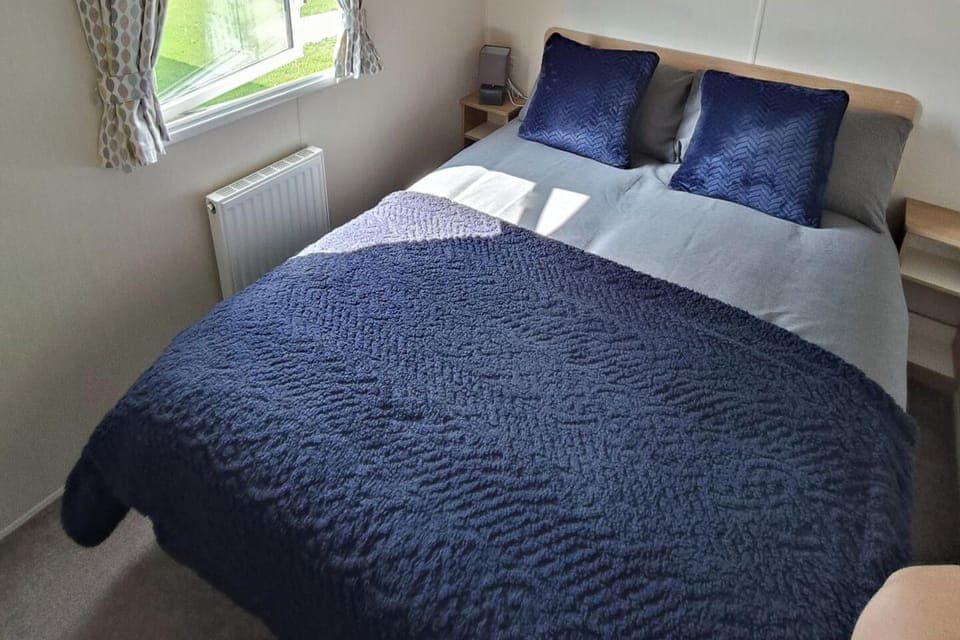 Main bedroom includes double bed, wardrobe, and vanity unit 