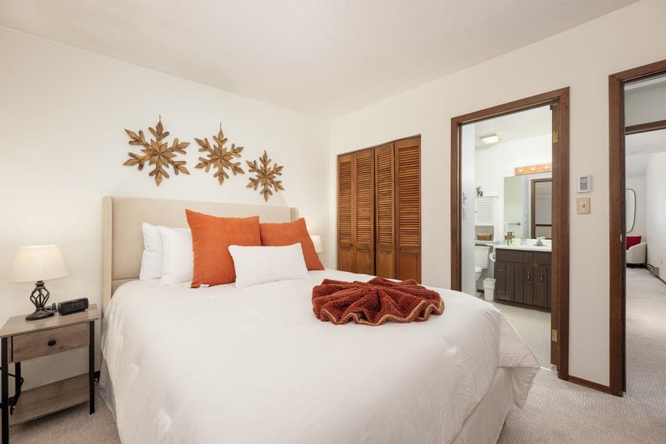 Drift off in your cozy bedroom with crisp linens, warm autumn accents, and an ensuite bathroom just steps away.