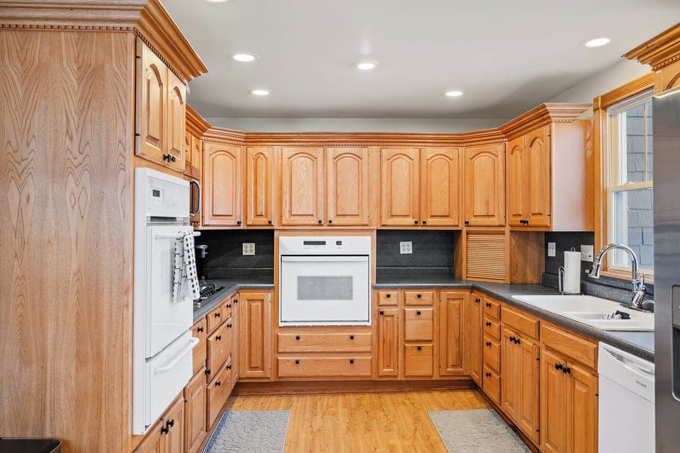 Spacious kitchen featuring natural wood cabinets, built-in oven, and ample prep space—perfect for family meals or group stays.