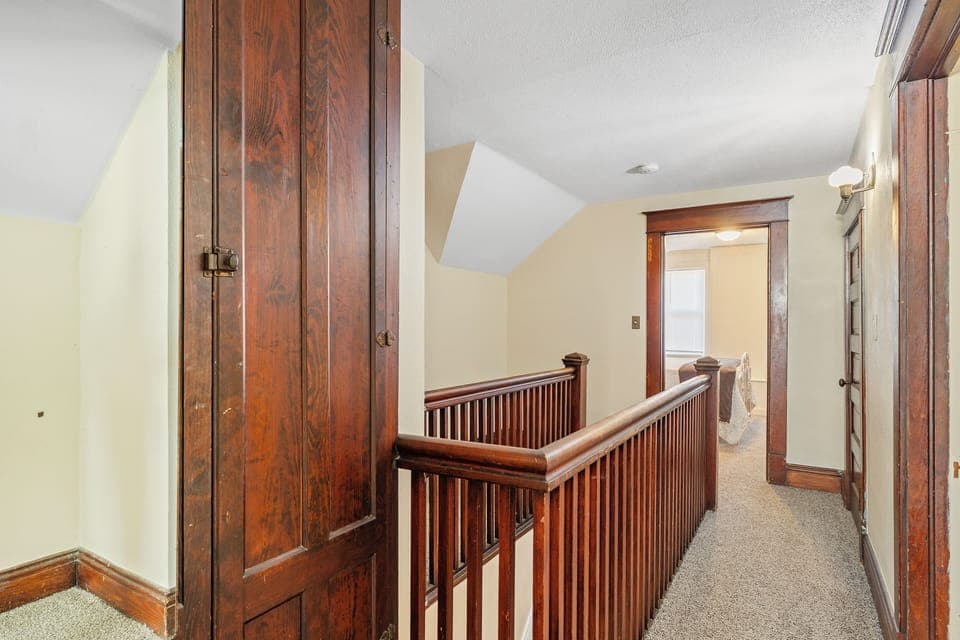Stairwell overlooking a bedroom, creating an open and airy feel.